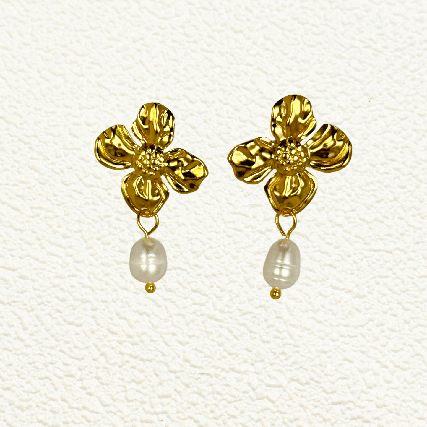 Textured gold floral pearl drop earrings with white teardrop-shaped pearls on waterproof stainless steel studs
