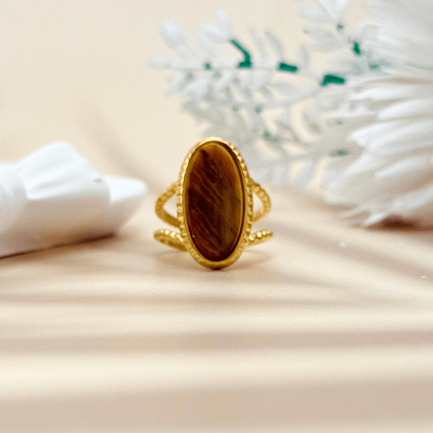 gold statement ring with large oval tiger eye stone and double textured band design.