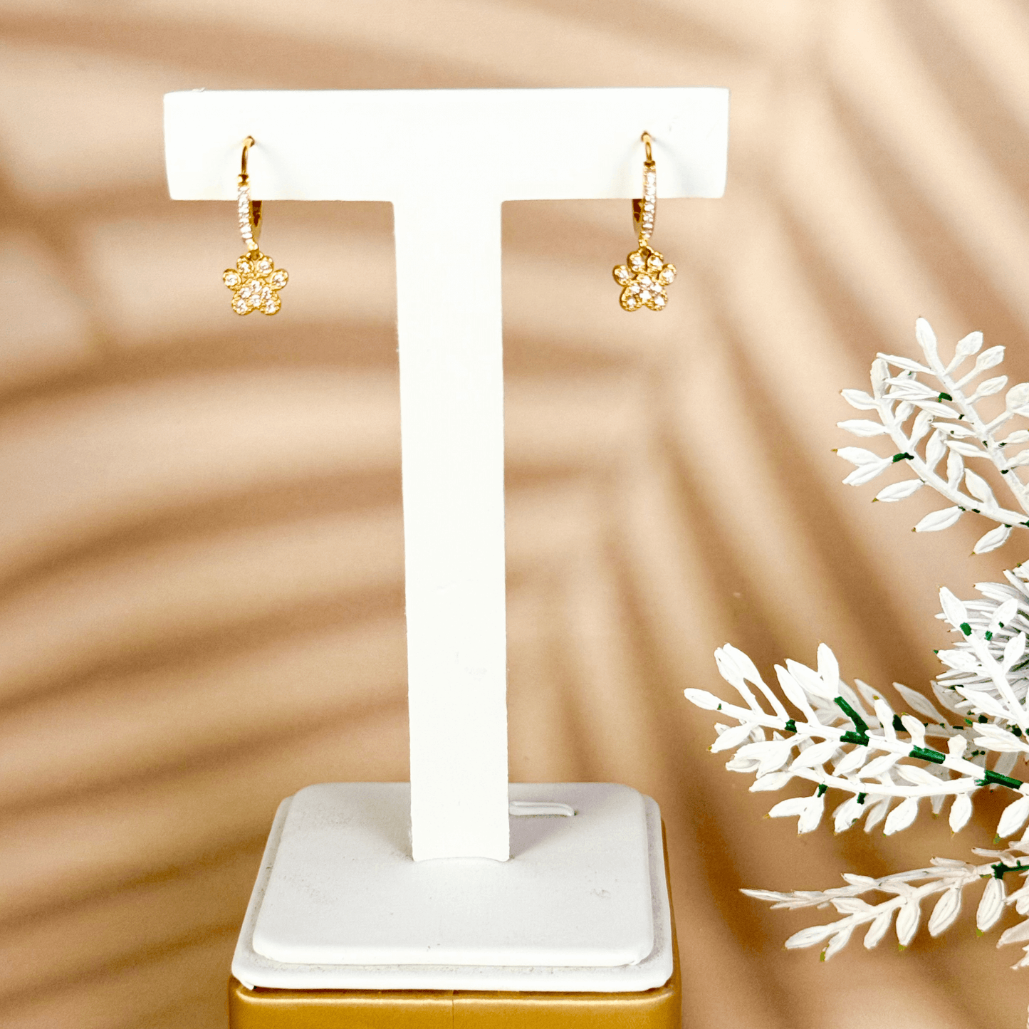 Tiny gold huggie earrings with a sparkling zircon-studded paw charm, waterproof hypoallergenic jewellery for animal lovers or pet parents