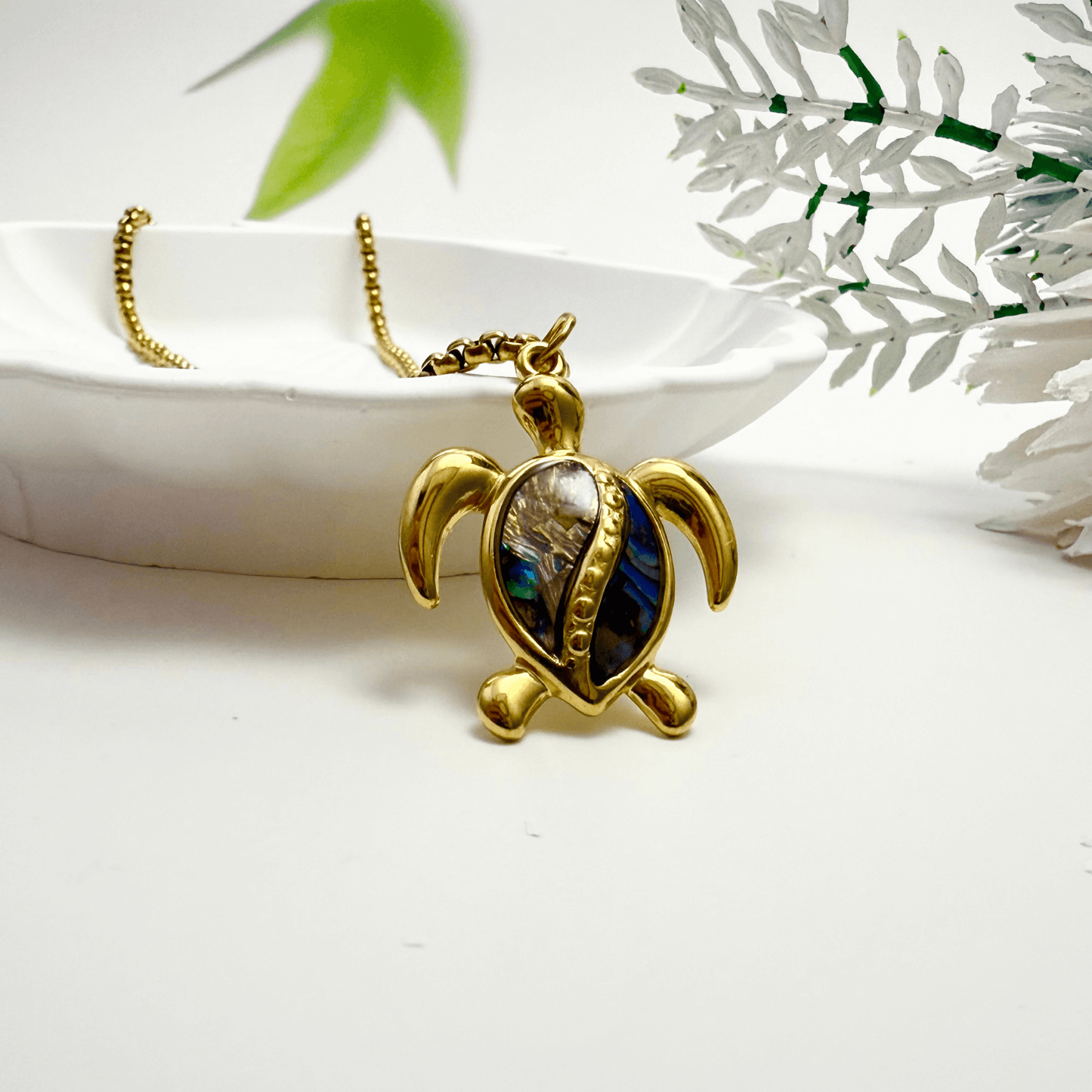 Waterproof gold turtle pendant necklace with abalone shell, shown on model with ocean-inspired details