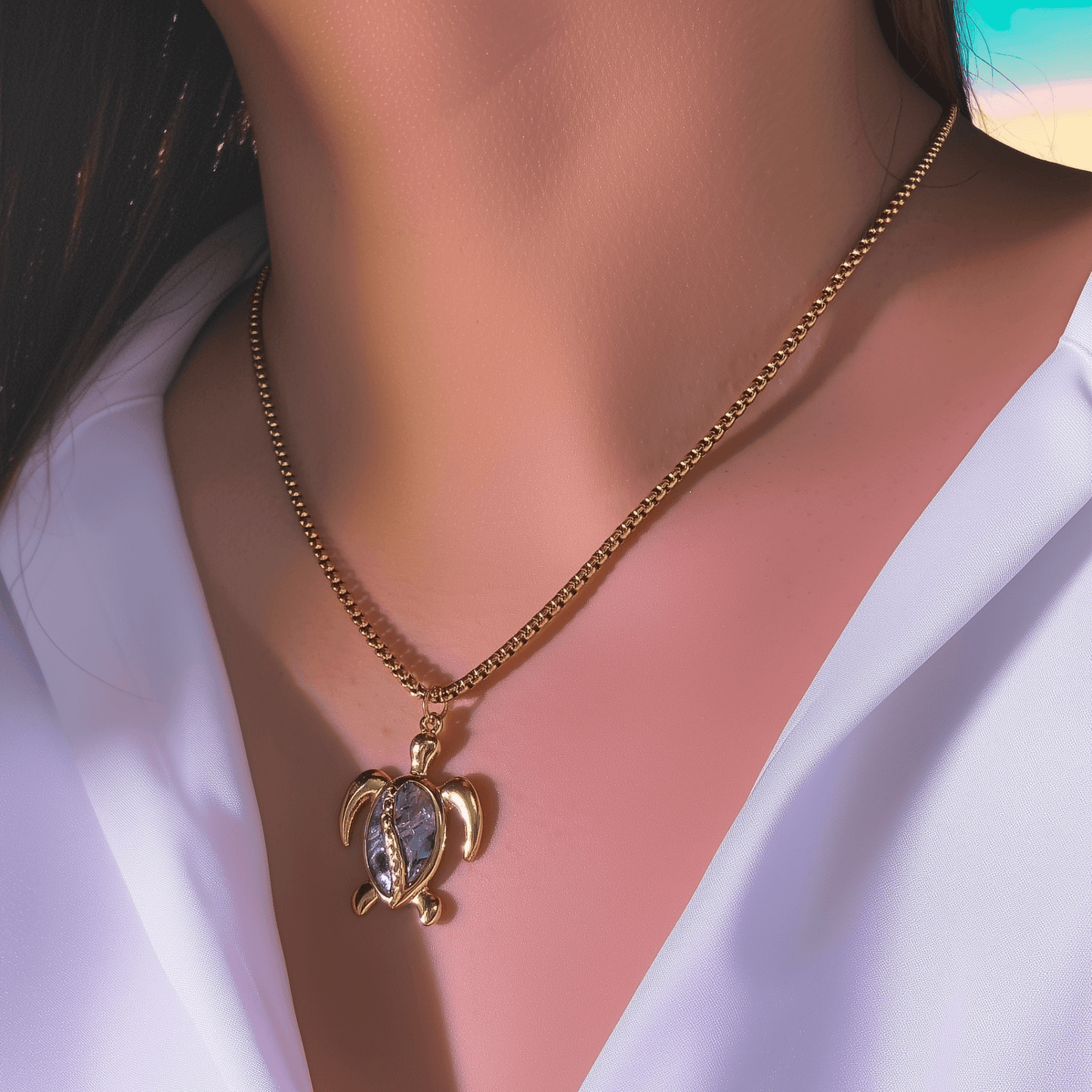 Waterproof gold turtle pendant necklace with abalone shell, shown on model with ocean-inspired details