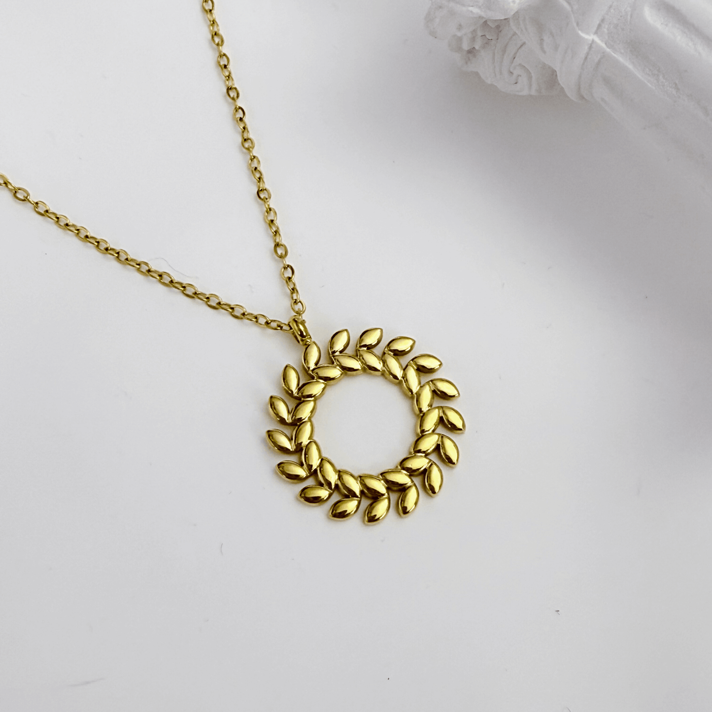 Gold laurel wreath necklace symbolising progress and resilience – MXW Jewellery