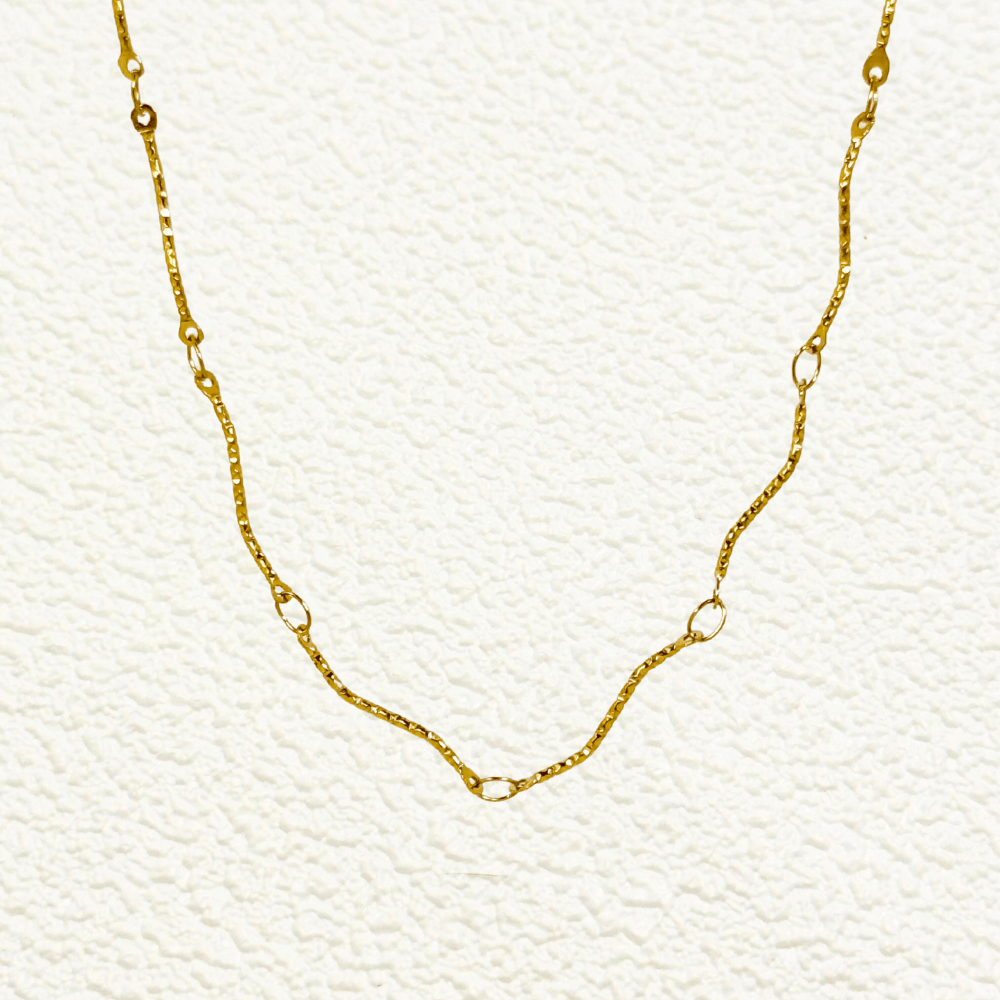 Wave Link Gold Chain made from waterproof gold PVD-plated stainless steel with textured wavy links