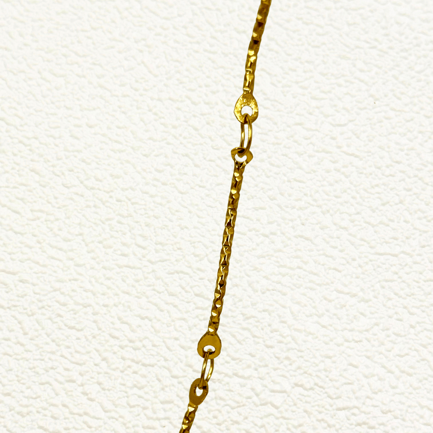 Wave Link Gold Chain made from waterproof gold PVD-plated stainless steel with textured wavy links
