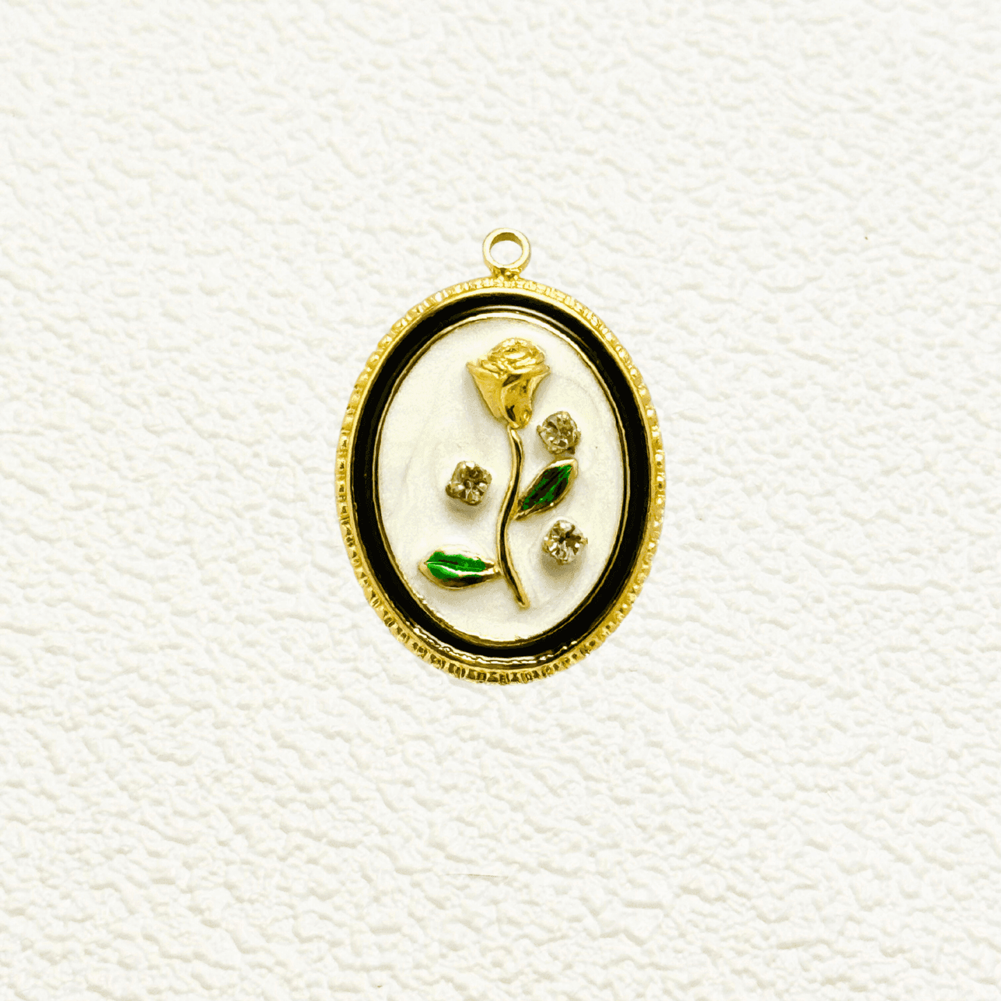 Elegant oval charm with sculpted golden rose, green enamel leaves, and embedded zircon accents on white enamel – floral vintage-style pendant for custom necklaces.
