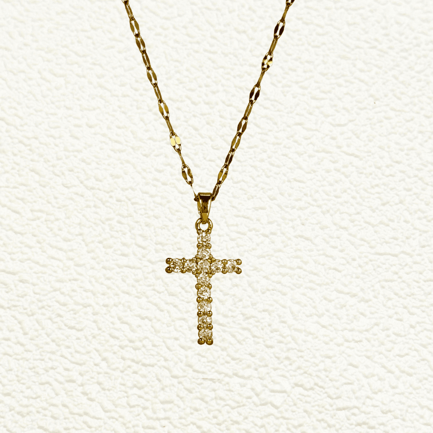 Gold-plated zircon cross pendant necklace with textured link chain, shown on display and close-up views – MXW Jewellery.