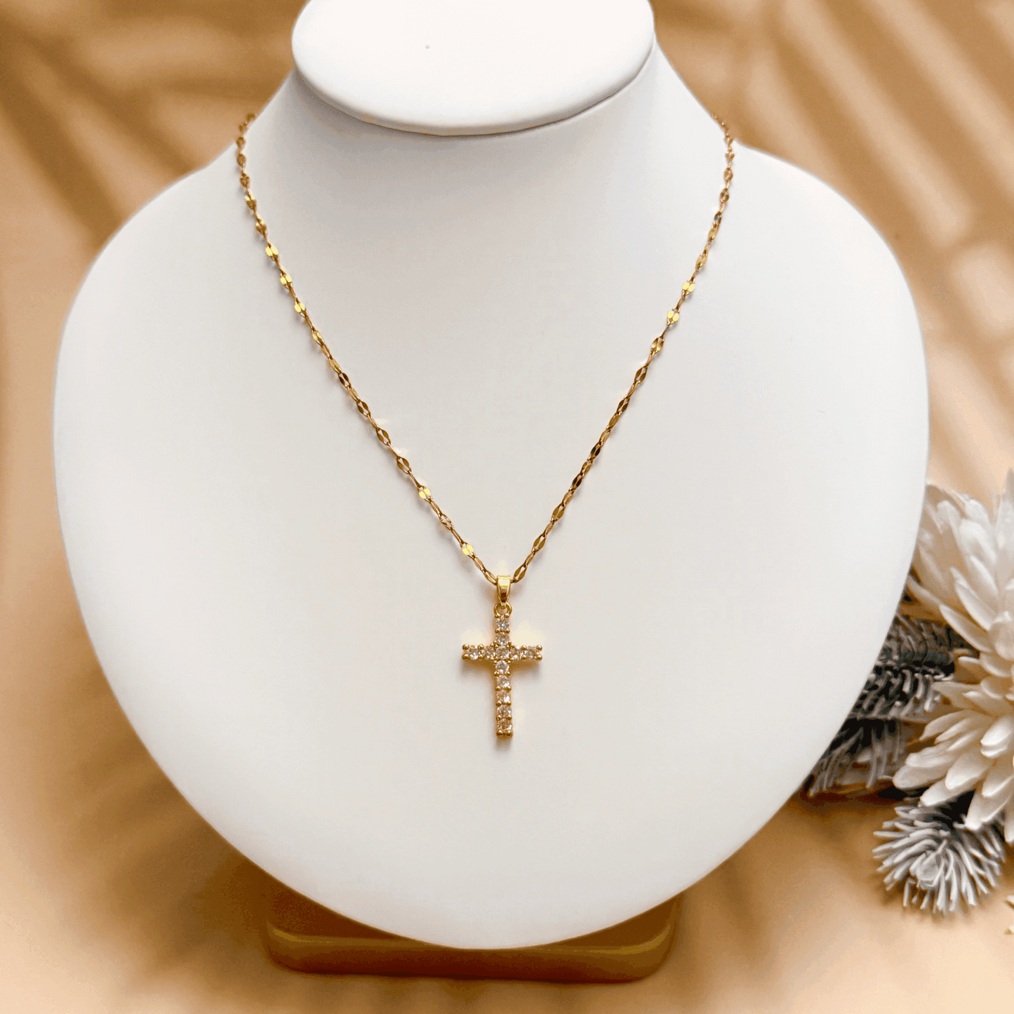 Gold-plated zircon cross pendant necklace with textured link chain, shown on display and close-up views – MXW Jewellery.