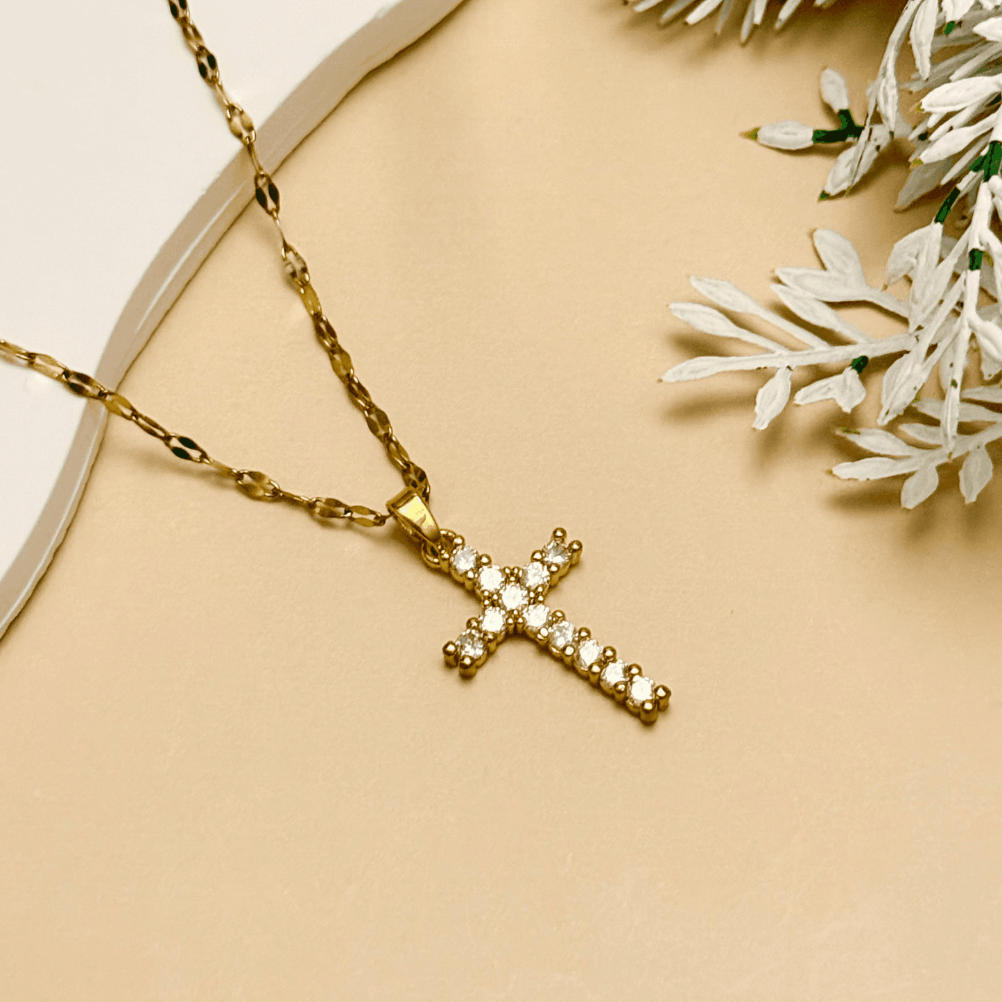 Gold-plated zircon cross pendant necklace with textured link chain, shown on display and close-up views – MXW Jewellery.