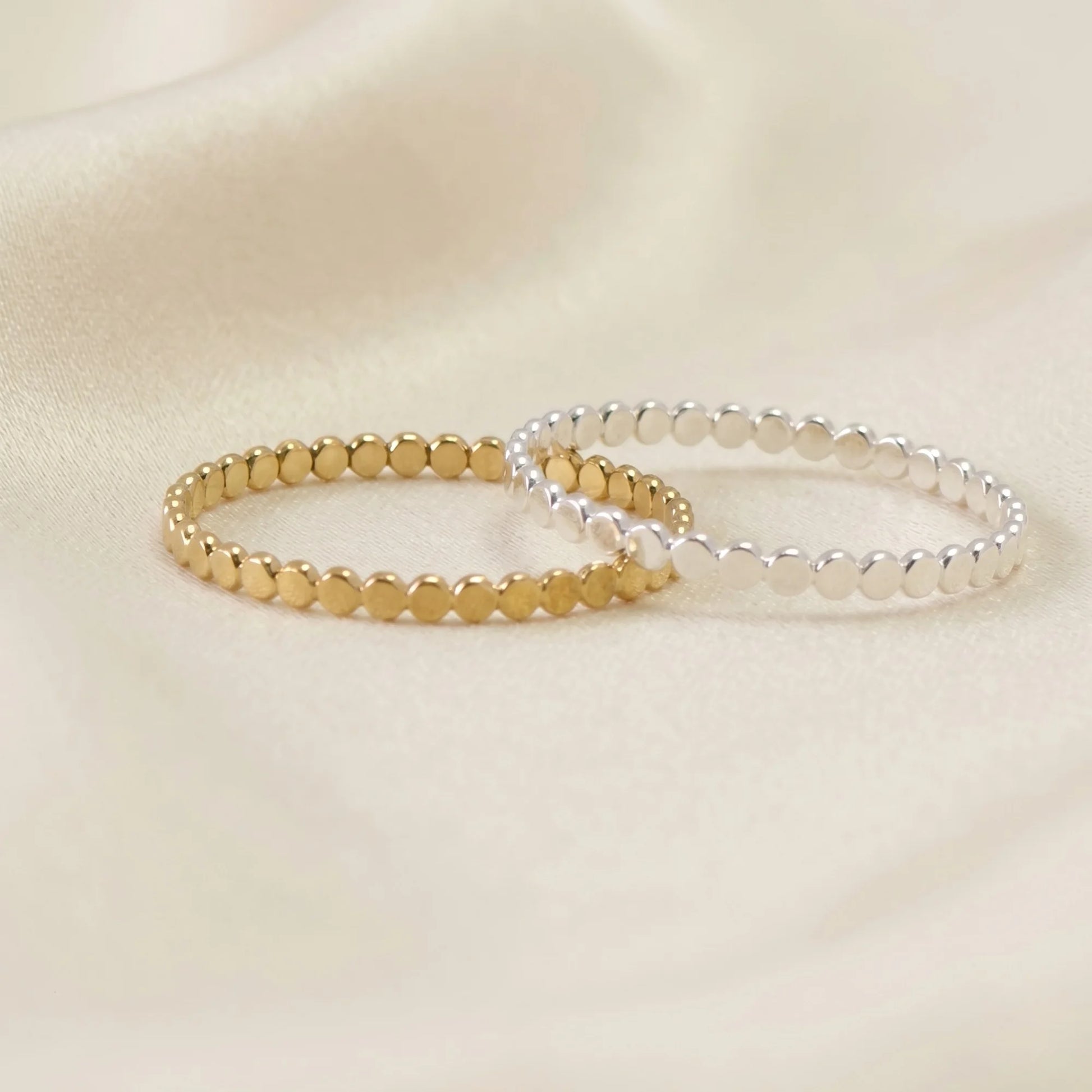 Dainty sterling silver stacking ring with small light-catching disc details