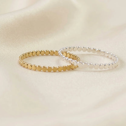Dainty sterling silver stacking ring with small light-catching disc details