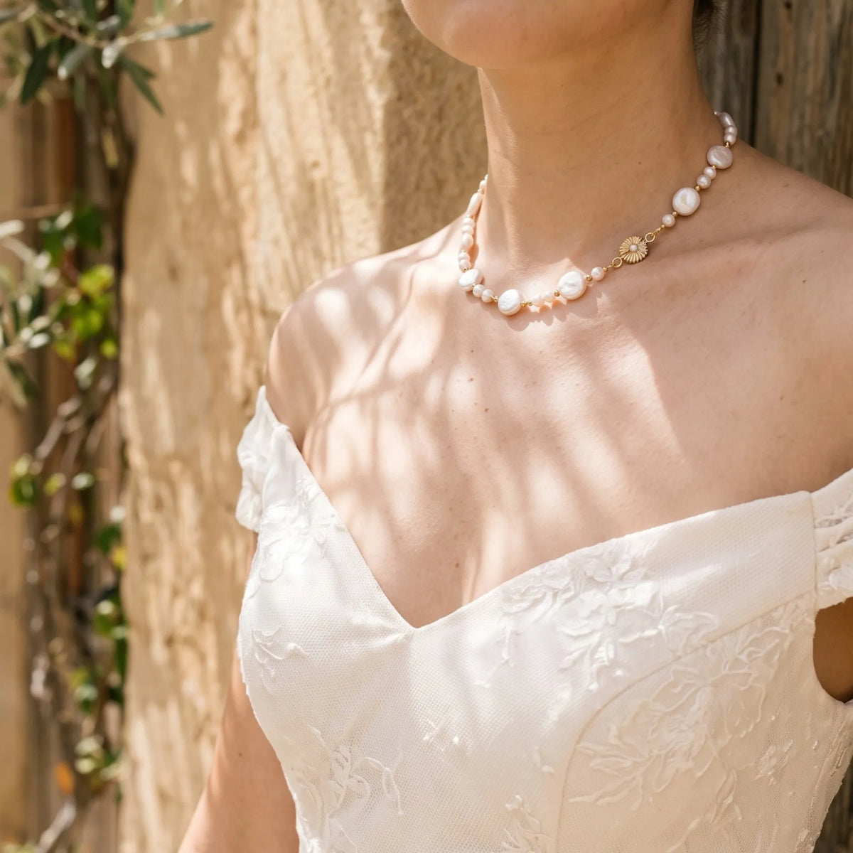 Gold vermeil necklace of coin and round freshwater pearls with small gold beads and a sculpted daisy connector