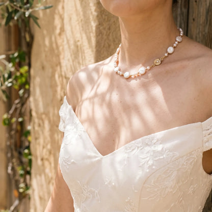 Gold vermeil necklace of coin and round freshwater pearls with small gold beads and a sculpted daisy connector