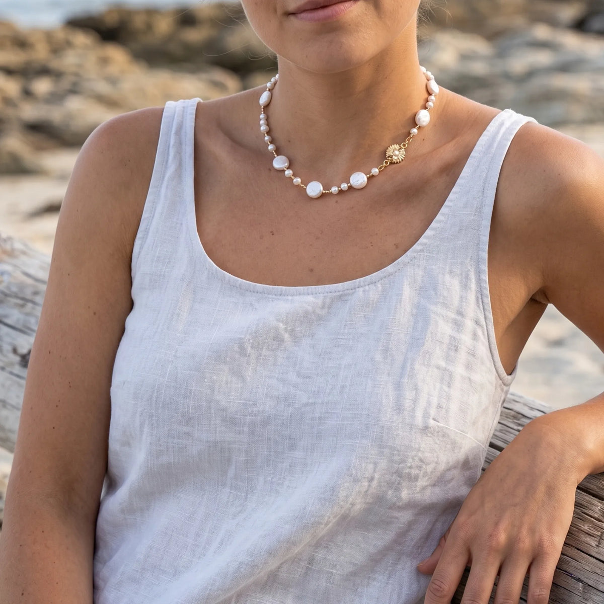 Gold vermeil necklace of coin and round freshwater pearls with small gold beads and a sculpted daisy connector