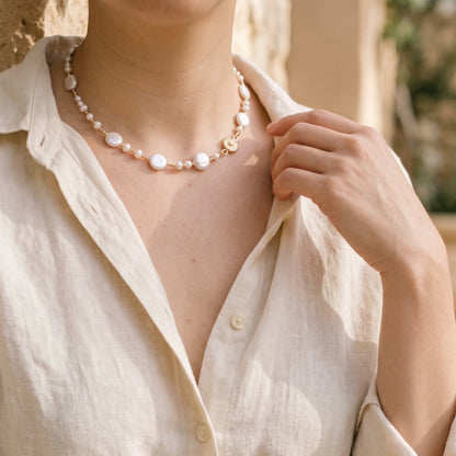 Gold vermeil necklace of coin and round freshwater pearls with small gold beads and a sculpted daisy connector