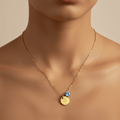 gold birth month necklace with blue crystal and engraved flower pendant
