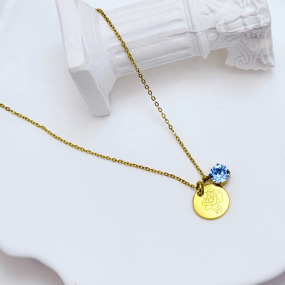 gold birth month necklace with blue crystal and engraved flower pendant