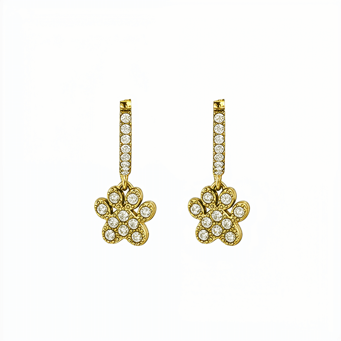 Close up of Gold Paw Print Huggie Earrings featuring paved crystals and a high-polish finish by MXW Jewellery