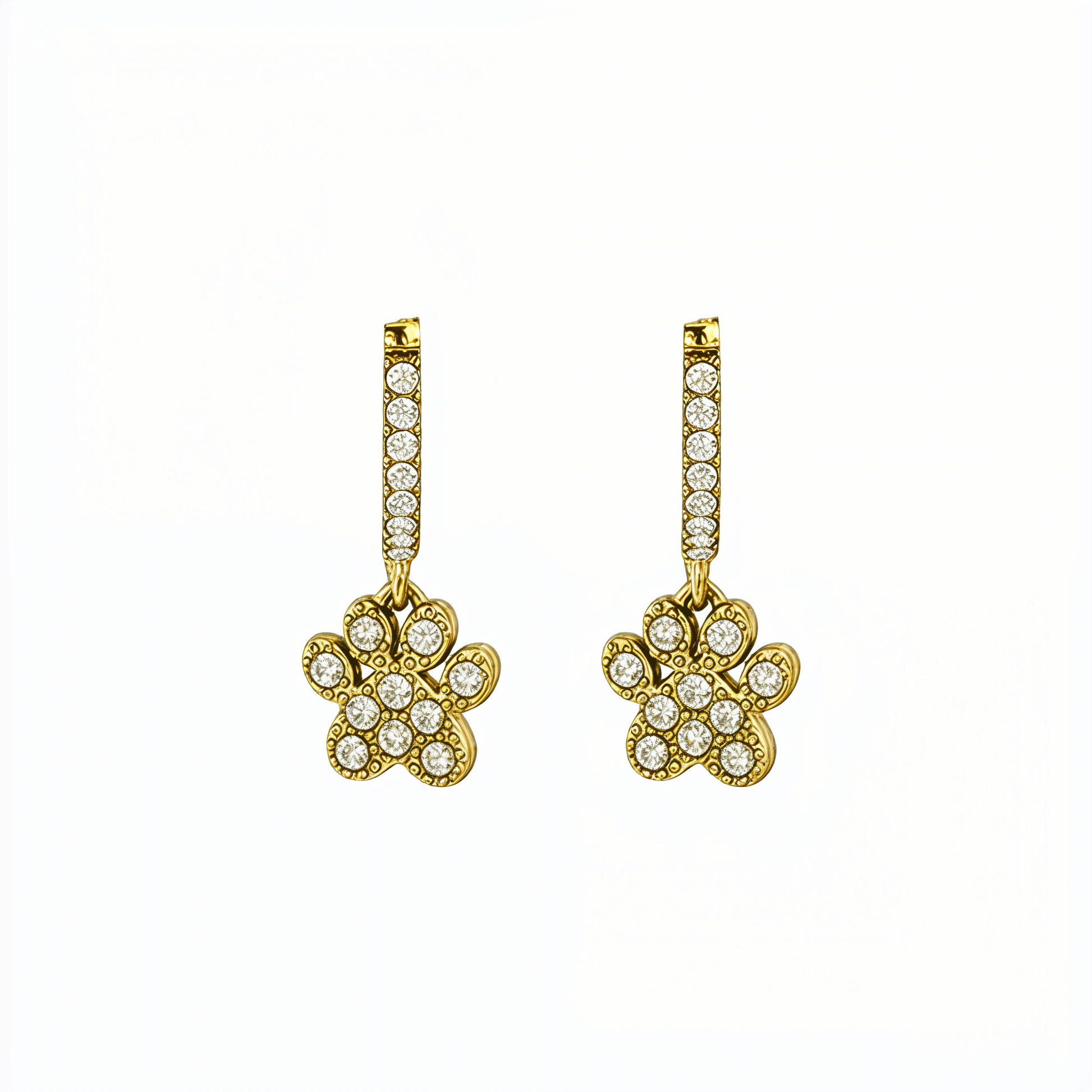 Close up of Gold Paw Print Huggie Earrings featuring paved crystals and a high-polish finish by MXW Jewellery