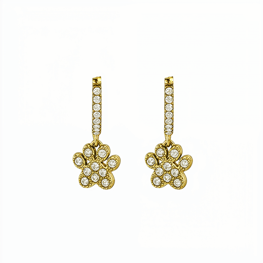 Close up of Gold Paw Print Huggie Earrings featuring paved crystals and a high-polish finish by MXW Jewellery