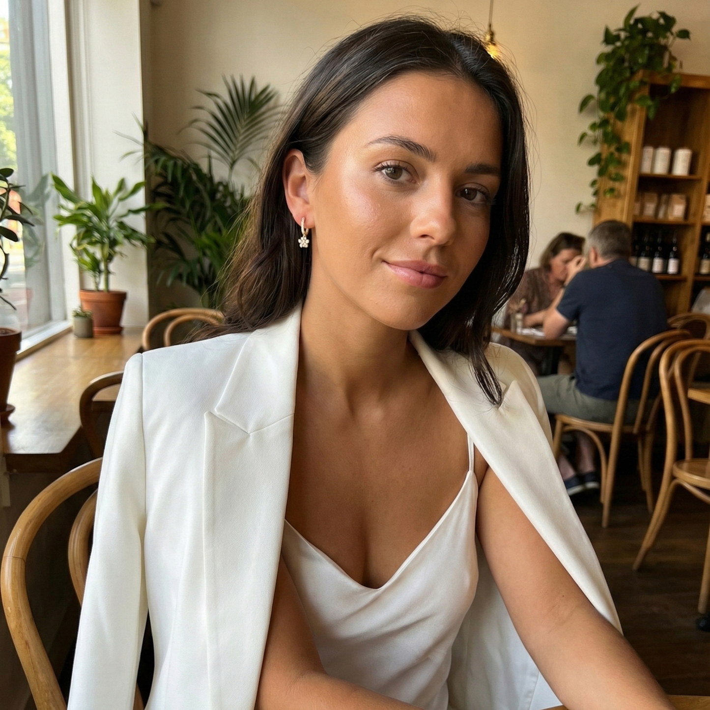 Close up of Gold Paw Print Huggie Earrings featuring paved crystals and a high-polish finish by MXW Jewellery