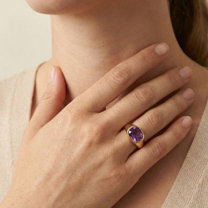 Gold ring with a cushion-cut amethyst-purple zircon gemstone.