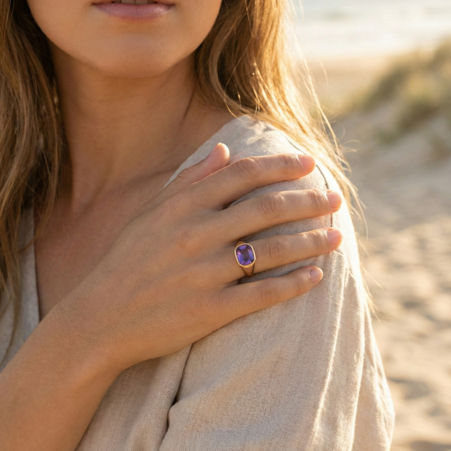 Gold ring with a cushion-cut amethyst-purple zircon gemstone.