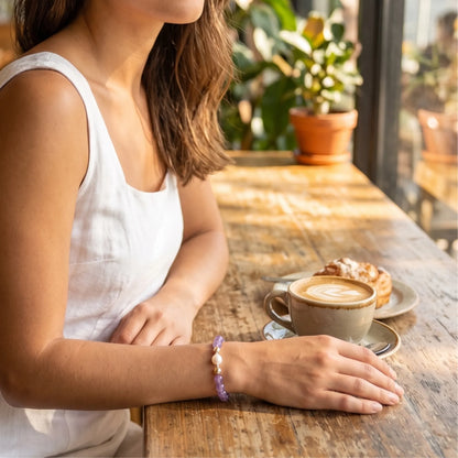 A beaded bracelet featuring Amethyst beads, premium freshwater pearl, and stamped initial disc, 14k gold filled. MXW Jewellery.