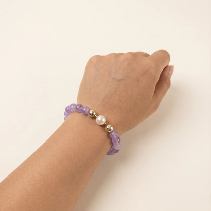 A beaded bracelet featuring Amethyst beads, premium freshwater pearl, and stamped initial disc, 14k gold filled. MXW Jewellery.