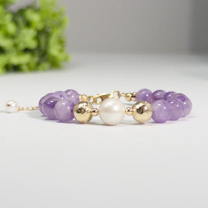 A beaded bracelet featuring Amethyst beads, premium freshwater pearl, and stamped initial disc, 14k gold filled. MXW Jewellery.