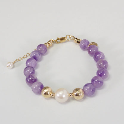 A beaded bracelet featuring Amethyst beads, premium freshwater pearl, and stamped initial disc, 14k gold filled. MXW Jewellery.