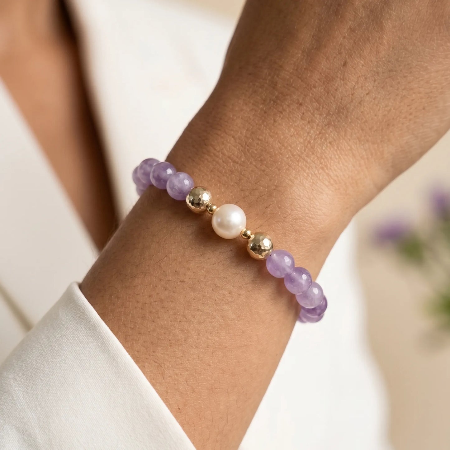 A beaded bracelet featuring Amethyst beads, premium freshwater pearl, and stamped initial disc, 14k gold filled. MXW Jewellery.