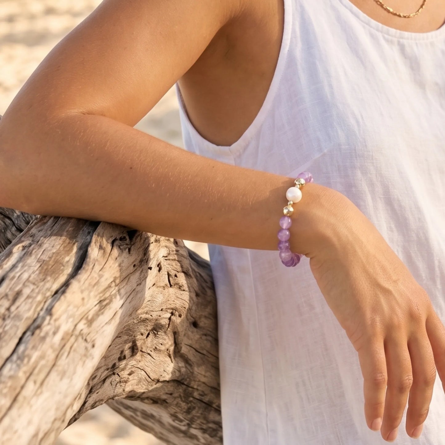 A beaded bracelet featuring Amethyst beads, premium freshwater pearl, and stamped initial disc, 14k gold filled. MXW Jewellery.