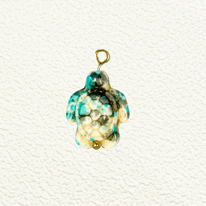 Turquoise-toned synthetic stone turtle charm with hexagonal mosaic shell pattern and gold bead detail