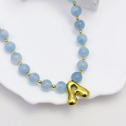 Natural aquamarine and 14K gold filled beaded necklace with personalised gold bubble initial charm, hand-finished in Australia