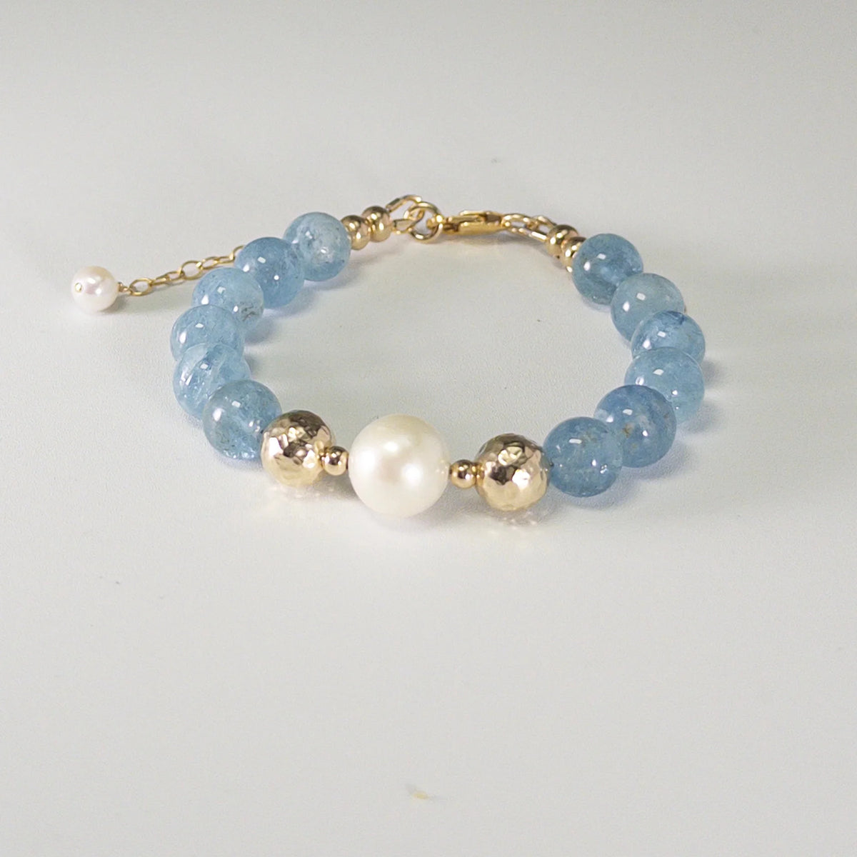 Aquamarine, pearl and initial gold bracelet featuring AAA-grade aquamarine beads, lustrous pearls and a personalised gold-filled stamped initial disc.