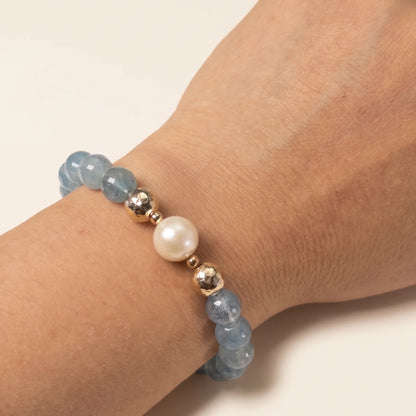 Aquamarine, pearl and initial gold bracelet featuring AAA-grade aquamarine beads, lustrous pearls and a personalised gold-filled stamped initial disc.
