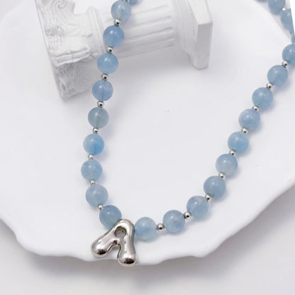 Aquamarine Silver Bubble Initial Necklace with natural aquamarine beads, sterling silver accents and personalised silver initial charm – MXW Jewellery