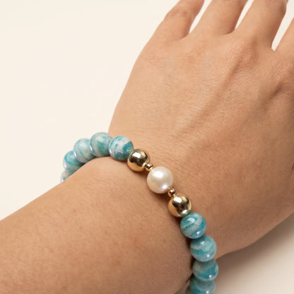 A beaded bracelet featuring banded amazonite gemstone beads, premium freshwater pearl, and personalised stamped initial disc, 14k gold filled. MXW Jewellery
