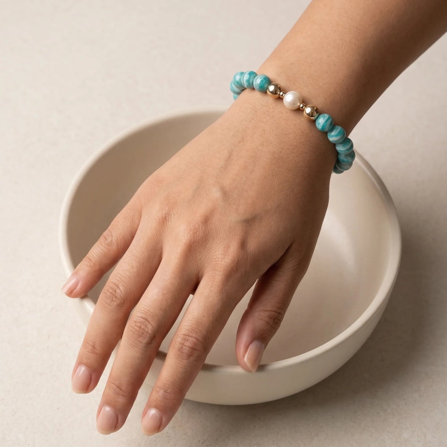A beaded bracelet featuring banded amazonite gemstone beads, premium freshwater pearl, and personalised stamped initial disc, 14k gold filled. MXW Jewellery