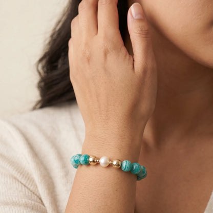 A beaded bracelet featuring banded amazonite gemstone beads, premium freshwater pearl, and personalised stamped initial disc, 14k gold filled. MXW Jewellery