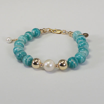 A beaded bracelet featuring banded amazonite gemstone beads, premium freshwater pearl, and personalised stamped initial disc, 14k gold filled. MXW Jewellery