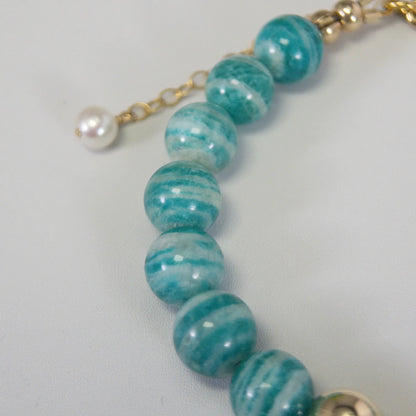 A beaded bracelet featuring banded amazonite gemstone beads, premium freshwater pearl, and personalised stamped initial disc, 14k gold filled. MXW Jewellery