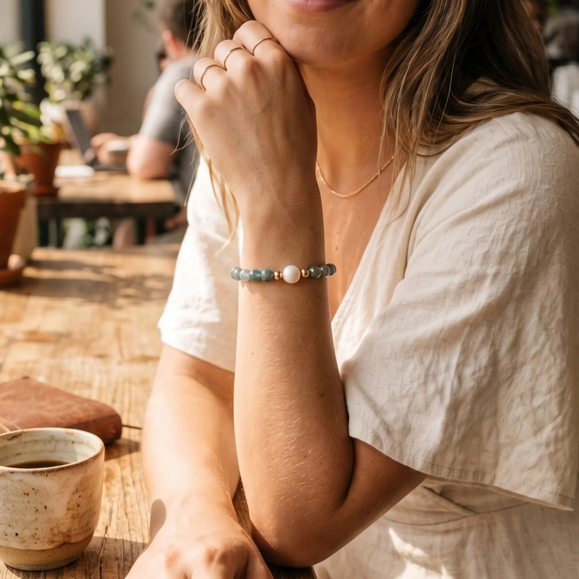 Bicolor kyanite, pearl and initial gold bracelet featuring naturally zoned blue-green gemstone beads, lustrous freshwater pearls and a personalised gold-filled stamped initial disc.