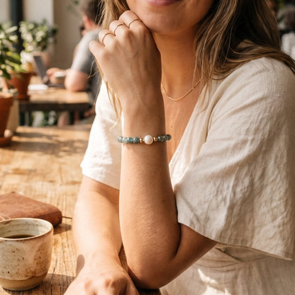 Bicolor kyanite, pearl and initial gold bracelet featuring naturally zoned blue-green gemstone beads, lustrous freshwater pearls and a personalised gold-filled stamped initial disc.