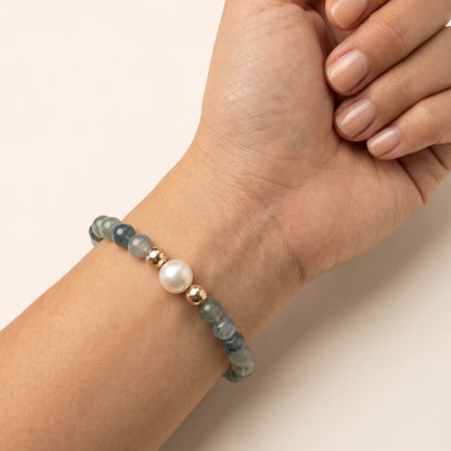 Bicolor kyanite, pearl and initial gold bracelet featuring naturally zoned blue-green gemstone beads, lustrous freshwater pearls and a personalised gold-filled stamped initial disc.
