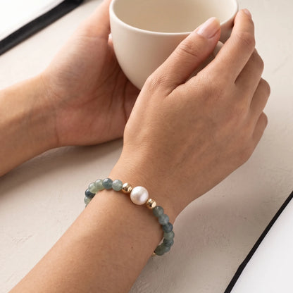 Bicolor kyanite, pearl and initial gold bracelet featuring naturally zoned blue-green gemstone beads, lustrous freshwater pearls and a personalised gold-filled stamped initial disc.