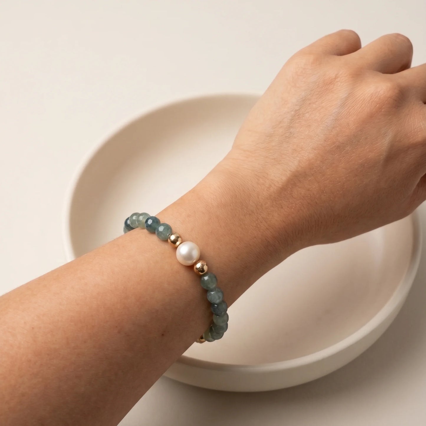 Bicolor kyanite, pearl and initial gold bracelet featuring naturally zoned blue-green gemstone beads, lustrous freshwater pearls and a personalised gold-filled stamped initial disc.