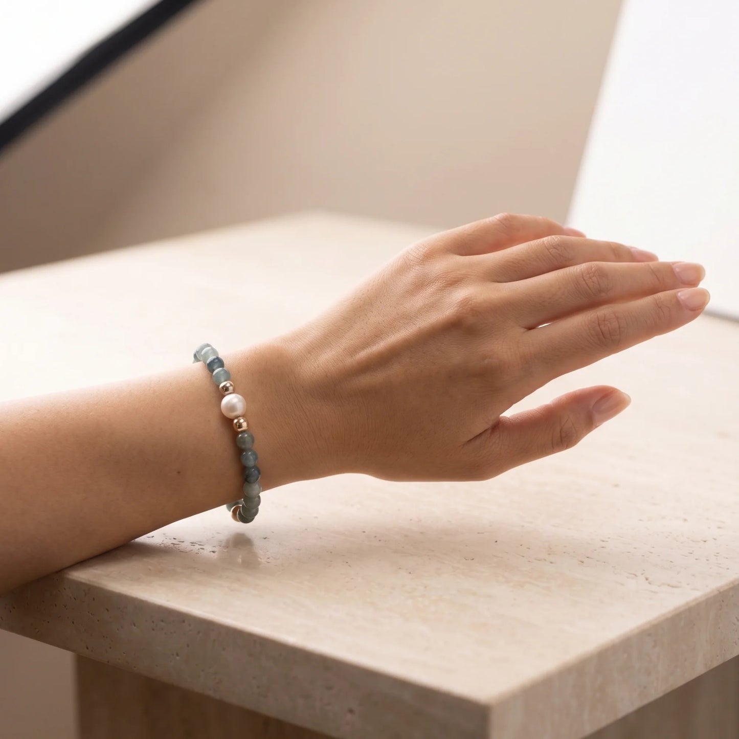 Bicolor kyanite, pearl and initial gold bracelet featuring naturally zoned blue-green gemstone beads, lustrous freshwater pearls and a personalised gold-filled stamped initial disc.