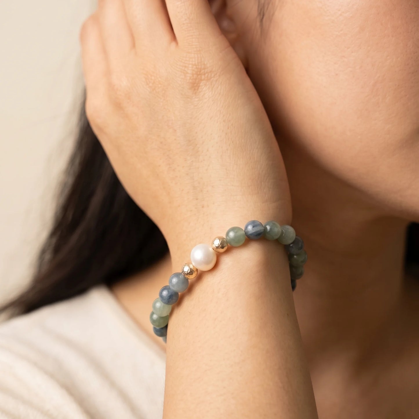 Bicolor kyanite, pearl and initial gold bracelet featuring naturally zoned blue-green gemstone beads, lustrous freshwater pearls and a personalised gold-filled stamped initial disc.