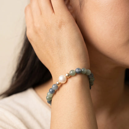Bicolor kyanite, pearl and initial gold bracelet featuring naturally zoned blue-green gemstone beads, lustrous freshwater pearls and a personalised gold-filled stamped initial disc.